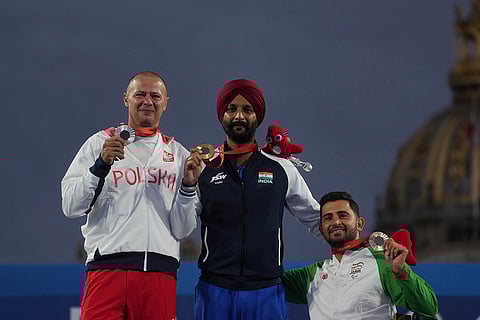2024 Paralympic Games Archery: Gold medalist Harvinder Singh, center, with silver medalist Lukasz Ciszek, left, and bronze medalist Mohammad Reza Arab Amiri